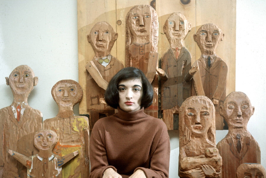 Portrait of French-born artist Marisol Escobar poses with some of her carved wooded sculptures. New York, New York, 1958. Courtesy Walter Sanders/The LIFE Picture Collection/Getty Images.