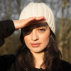 Cristina in the cream Pampa Cap ethically handmade by artisans for Awamaki knitwear brand based in Peru
