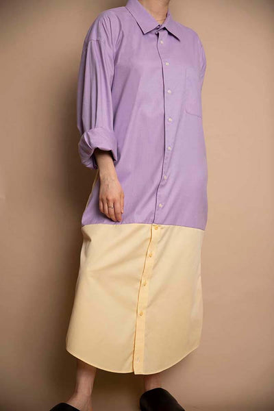 Colorblock design from two mens button up collared blouses. The top portion is lavender, lower portion is a pale yellow. Dress hits below the knee.