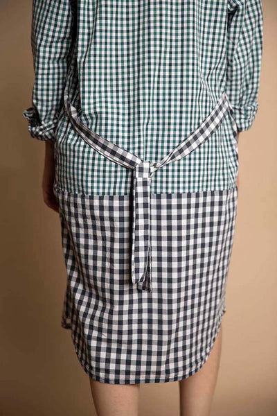 Back view of the boyfriend shirtdress in the double plaid colorblock. Features a black and white plaid pattern reworked into a strap for easy cinching behind.