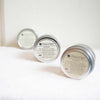 Three Pantry Product candles packaged in round aluminium tin cans.