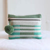 Small handwoven into coin purse made from sheeps wool. Mint and olive stripes. Features a brass zipper and mint pom pom detail.