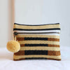 Small handwoven into coin purse made from sheeps wool. Pale yellow, brown, and black stripes. Features a brass zipper and yellow pom pom detail.