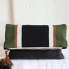Foldover clutch by Awamaki in green, brown and white with pom pom zipper detail and leather exterior