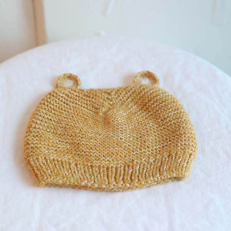 Yellow Muku Knit Llama Cap in yellow hand knitted from baby alpaca yarn by artisans in Peru. For ages 6-12 months.