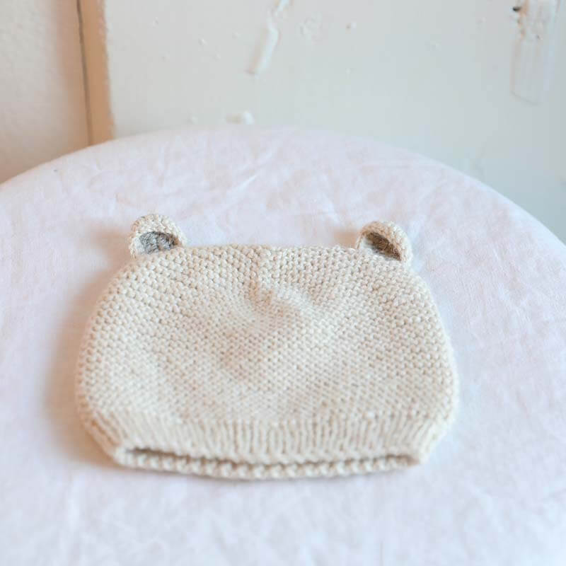 White Muku Knit Llama Cap hand knitted from baby alpaca yarn by artisans in Peru. For ages 6-12 months.