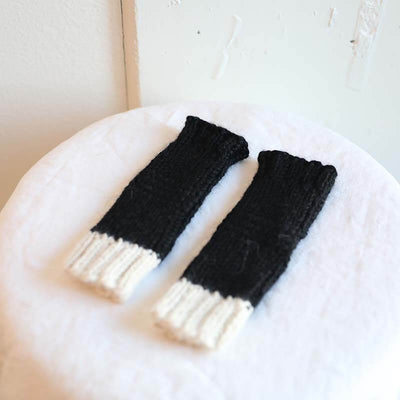Black and white fingerless gloves made from alpaca wool by Awamaki