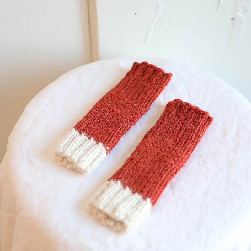 Rosewood and white fingerless gloves made from alpaca wool by Awamaki