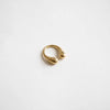 Brass statement ring against white background showcasing curves of design for the chunky wrap ring by ethical brand Bawa Hope