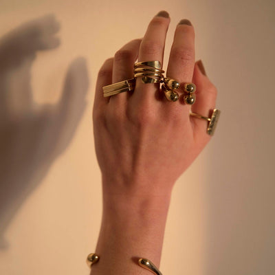 Brass Finger ring by Bawa Hope on middle finger designed to coil around in sustainable brass