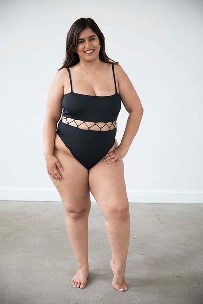 Black one piece bathing suit on size XL model has a corset feature at the midsection