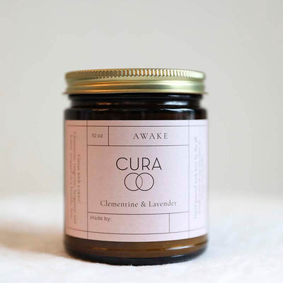 An awake scented candle by Cura and Prosperity ethically made in USA scented clementine and lavender
