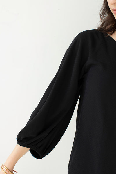 Up close shot of the black masako blouse with bell sleeves