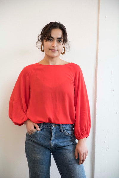 Sophia wearing the red masako blouse ethically made in Cambodia
