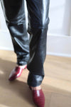 Black leather pants with no bottom seam, trousers have been handcut shorter.