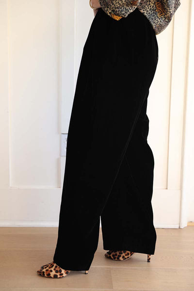 Velvet wide leg trousers in black worn with leopard heels and a silk bomber from the 80s