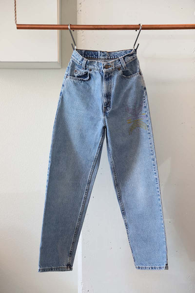 Hand embroidered denim ethically sourced by the Cura Co