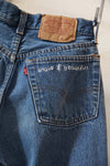 Brave and beautiful white embroidery work on denim pocket by Refugee Artisan Initiative