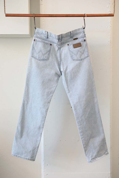 Back view of vintage wrangler denim with handembroidered quote on the back pocket