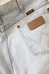 Brave & Beautiful motto in white thread emrboidered above the back pocket on a pair of vintage wrangler denim