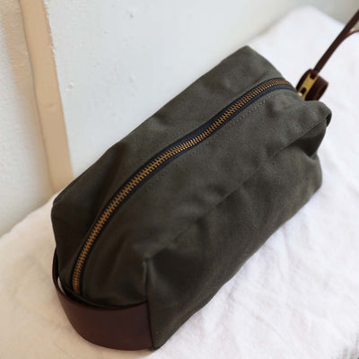 Detail shot of the Modern Dopp Kit featuring a full zipper and dark leather handles