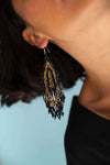Up close hand beaded earrings fair trade and made from small black and gold japanese crystal beads