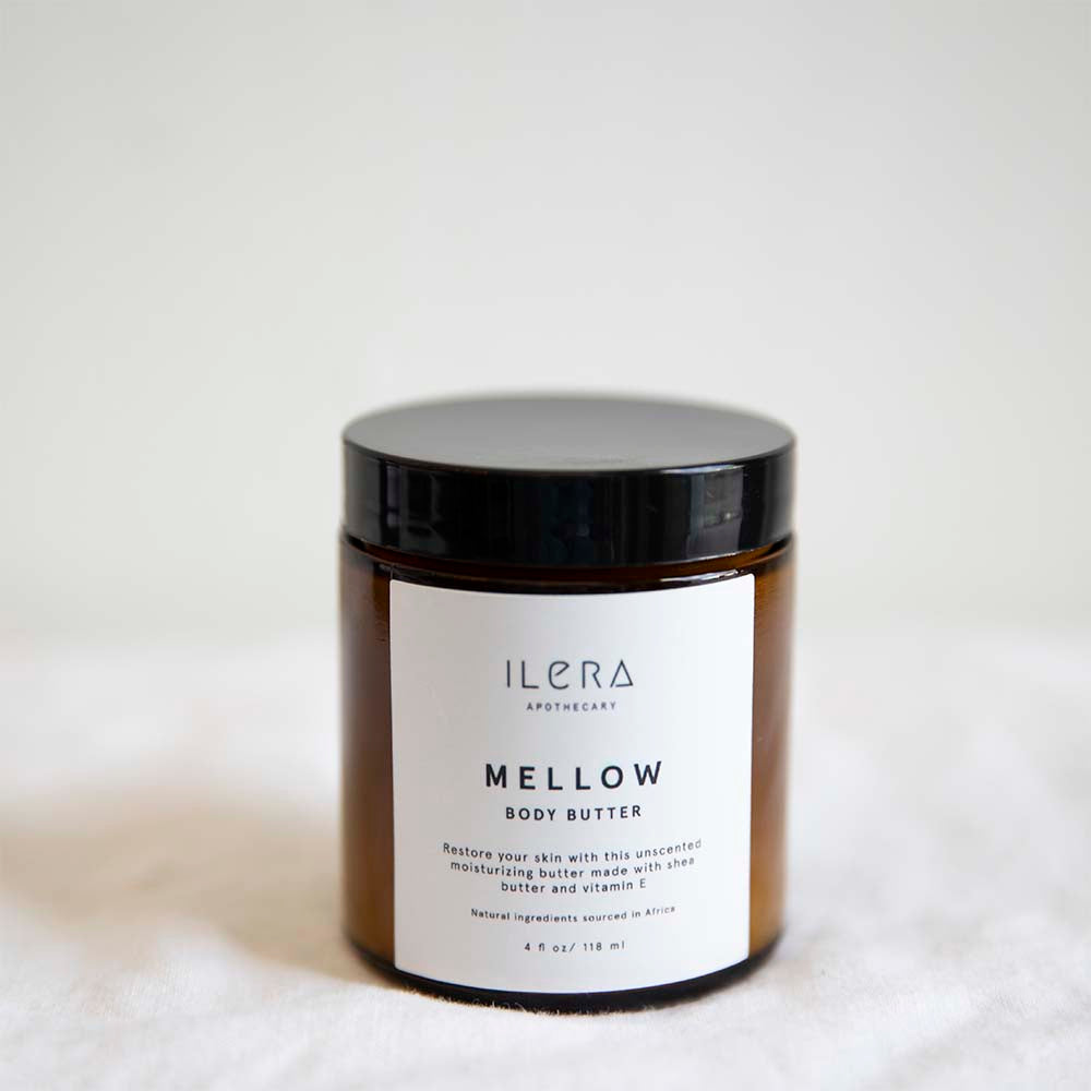 Mellow Body Butter ethically made with shea butter and vitamin e by Ilera Apothecary in amber packaging and black lid