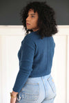 Side view of the soft blue cropped cardigan. Ethically made in Zhangjiagang. Has ribbed sleeves, hem .