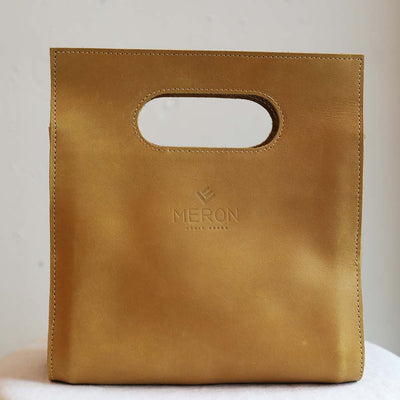 Mustard handmade cutout handle purse ethically made by Meron in Ethiopia with chromium free leather