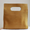 Back view of square leather cutout handle purse in mustard ethically made by artisans in Ethiopia