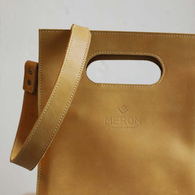 Handmade leather purse ethically made by Meron in Ethiopia with adjustable straps and a double pocket cardholder