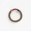Pichulik Aruba Bracelet in brown and red. Thin rope assembled with brass caps and embellished with wax cord.