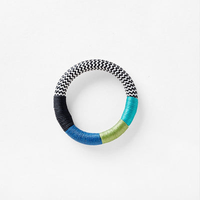 Pichulik dynamic bracelet in white zig zag, white, aqua, fern, blue colors. Loop-style rope configurations in woven static and dynamic rope, embellished with contrast wrapping