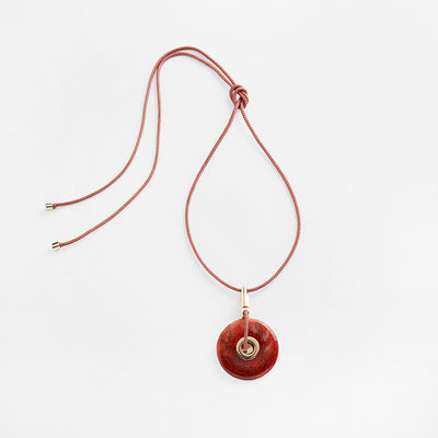 Pichulik Memoria Fire Agate Honey Pendant attached to an adjustable rope chord. Ethically made by Pichulik.