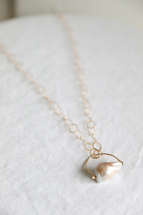 White Fireball Pearl pendant necklace ethically handmade by Regina Chang in Seattle, Washington. 