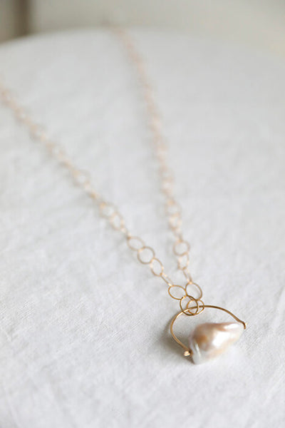 White Fireball Pearl pendant necklace ethically handmade by Regina Chang in Seattle, Washington.