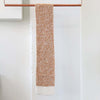 Handknitted scarf in muted orange with cream ends ethically made from 100% sustainably sourced alpaca fibers in Peru