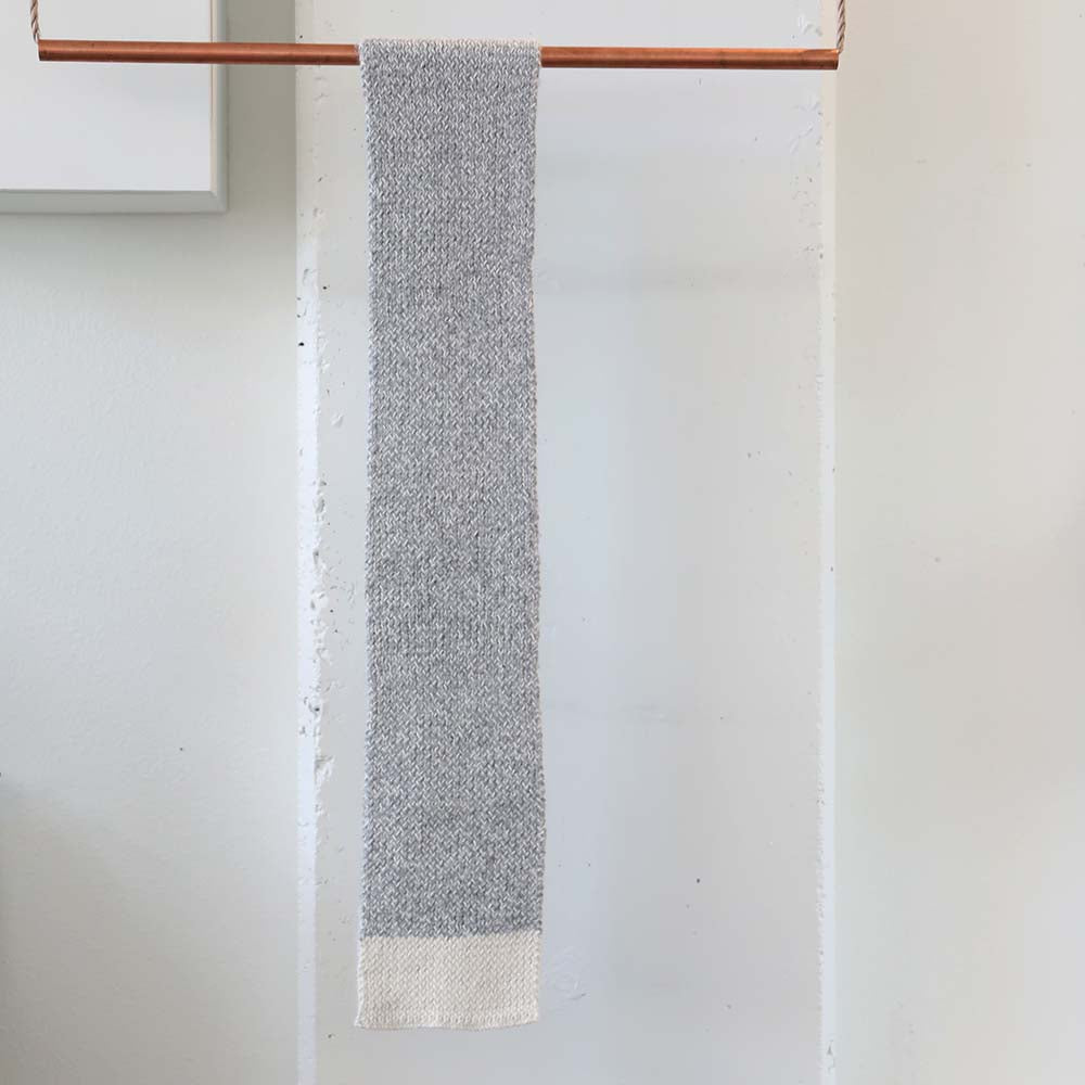 Handknitted scarf in grey with cream ends ethically made from 100% sustainably sourced alpaca fibers in Peru