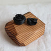 Hand sculpted polymer resin and upcycled hardwood sculpture with two black roses ethically made in Seattle Wa