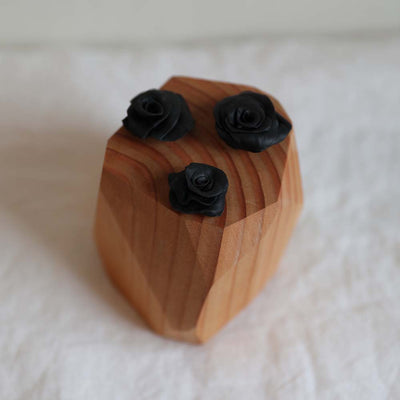 Hand sculpted polymer resin and upcycled hardwood sculpture with three black roses