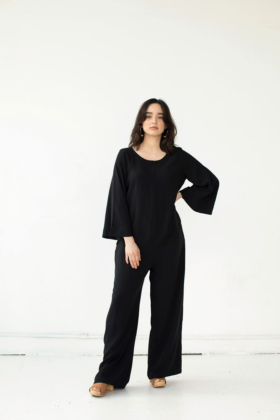 Cristina wears the black Tomoko Jumpsuit part of the Hanae Collection by The Cura Co