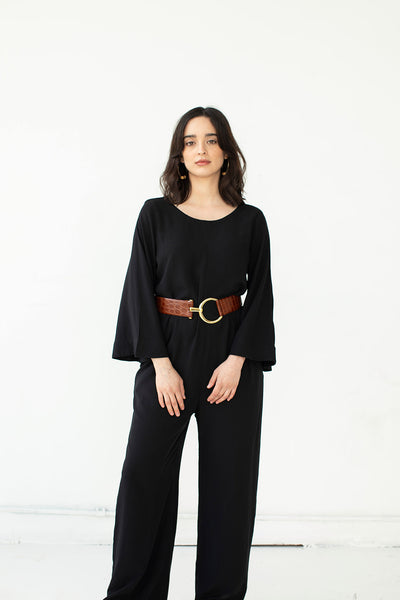Cristina wears the black Tomoko Jumpsuit styled with a burgundy leather belt. Jumpsuit is part of the Hanae Collection by The Cura Co