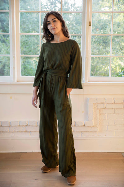Sophia wears the pencil stripe print Tomoko Jumpsuit part of the Hanae Collection by The Cura Co