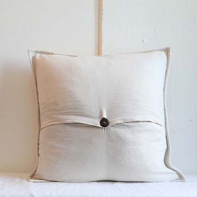 Hand-craved wood button closure on back side of the Marigold Pillowcase ethically made by artisans for Tonle