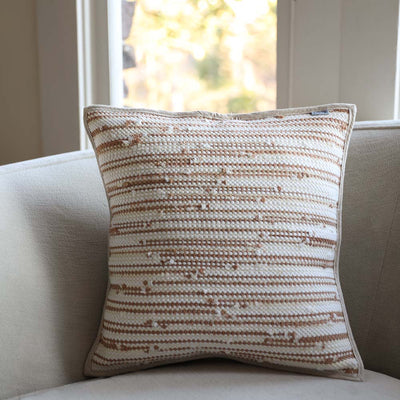 Zero-waste pillow in natural tones made from upcycled textile scraps, linen,  and cotton.